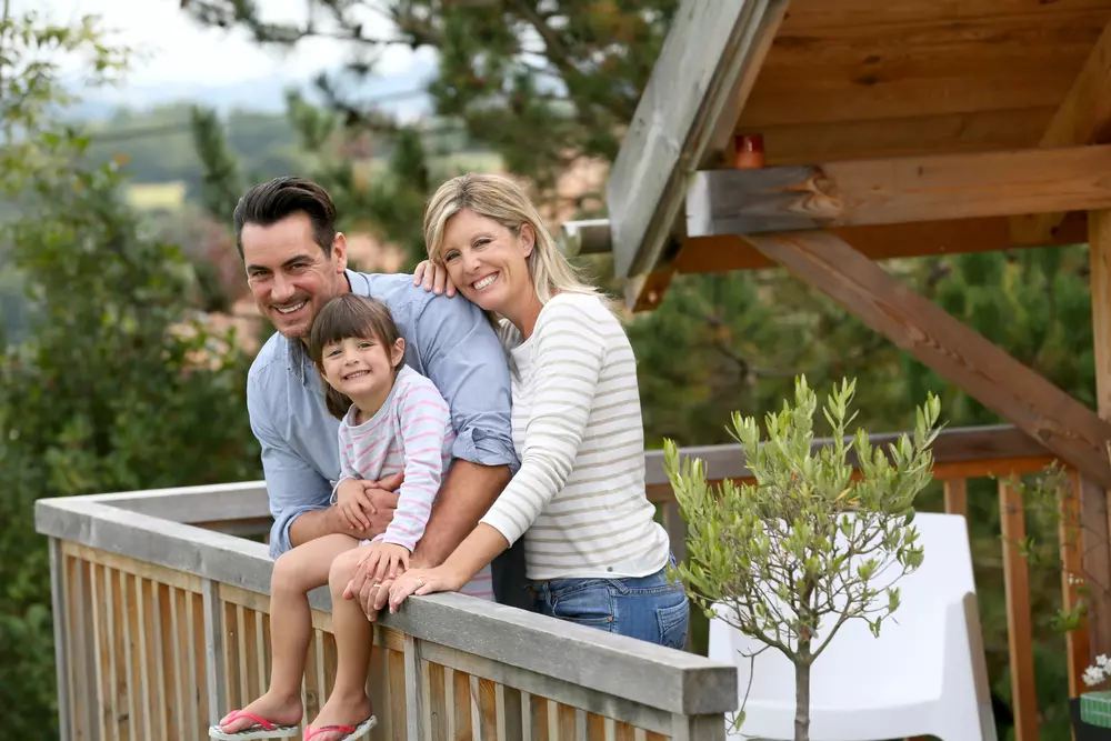 Family standing outside cabin on porch in Gatlinburg TN