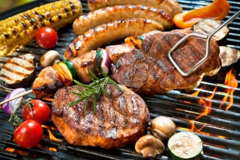 Meats and vegetables on the grill.